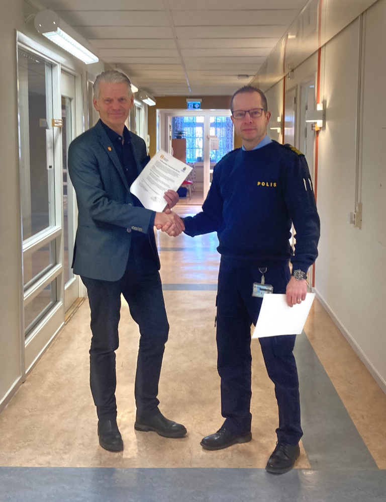 Peter Karlsson, kommunstyrelsens ordförande och Mattias Granqvist, lokalpolisområdeschef, skakar hand efter att ha signerat det nya medborgarlöftet.