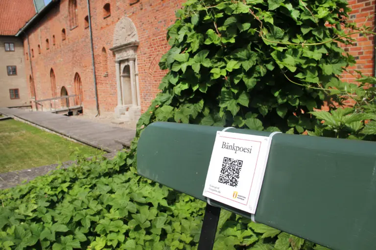 Parkbänk på Gräsgården med skylt med QR-kod